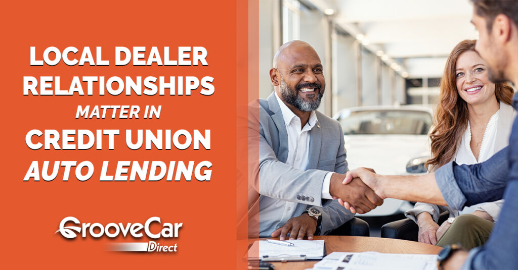 Credit union and auto dealership professionals shaking hands, representing local dealer relationships in credit union auto lending